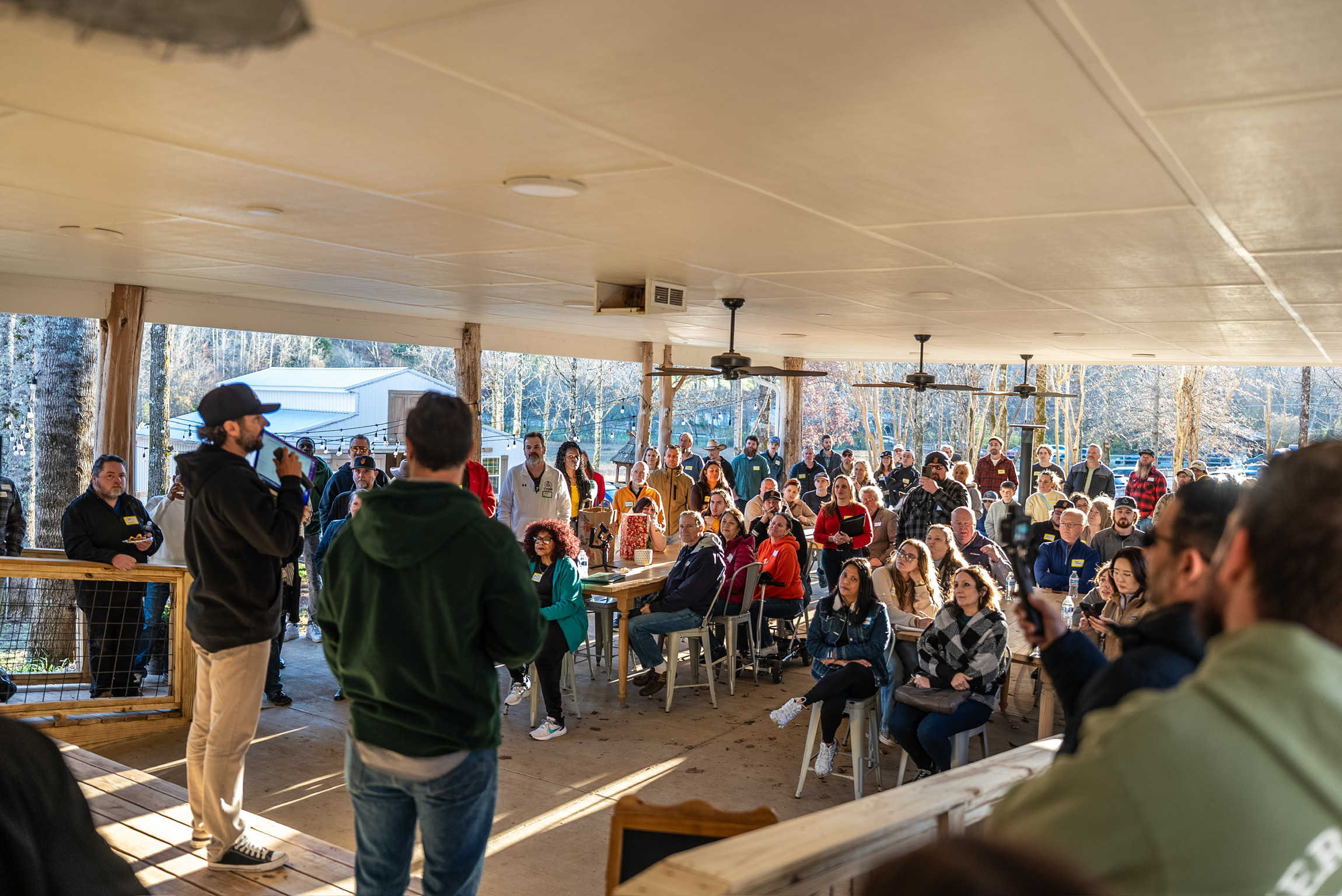 Teaching from stage at Ten Talents Farm